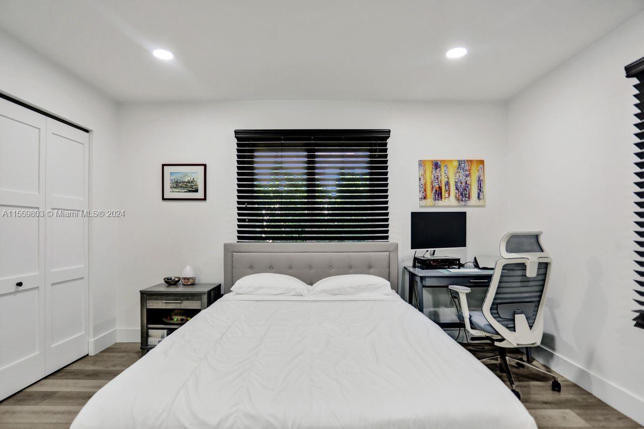 2800 Southwest 26th Street Miami, FL 33133 - Photo 50 of 72 a bedroom with a bed a desk and chair