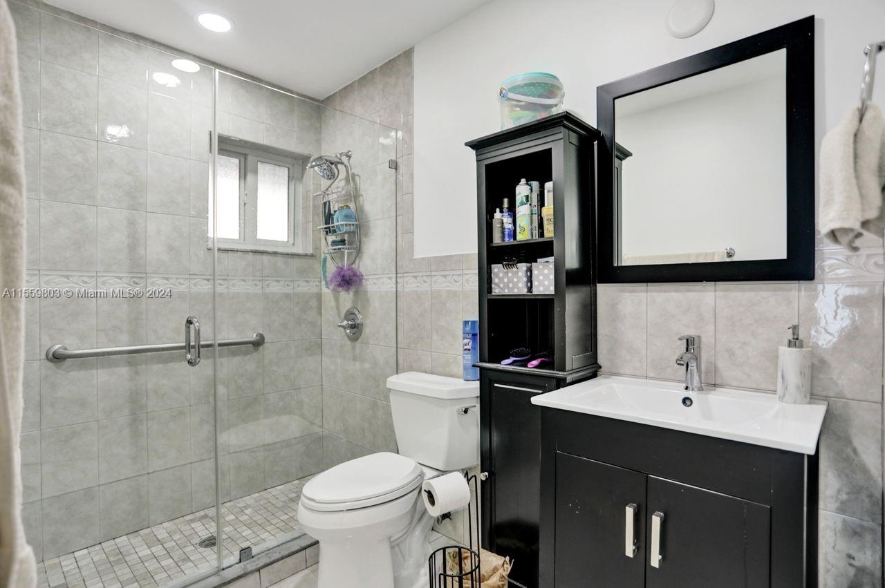 2800 Southwest 26th Street Miami, FL 33133 - Photo 8 of 72 a bathroom with a toilet sink shower and mirror