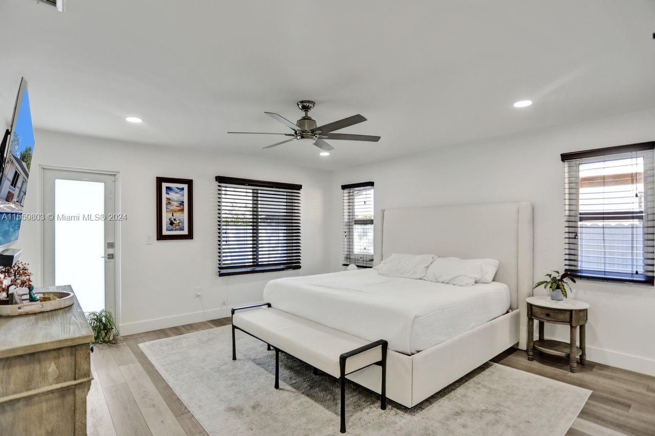 2800 Southwest 26th Street Miami, FL 33133 - Photo 9 of 72 a bedroom with a large bed and a chandelier