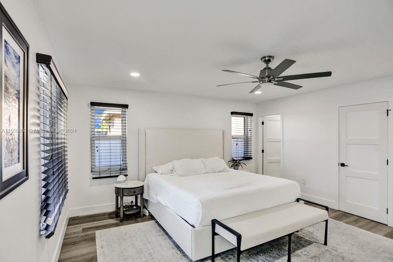 2800 Southwest 26th Street Miami, FL 33133 - Photo 10 of 72 a bedroom with a large bed and a chandelier