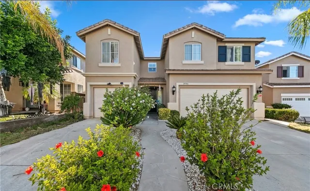 a front view of a house with a yard and a garden