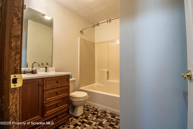 a bathroom with a sink toilet a shower and a mirror