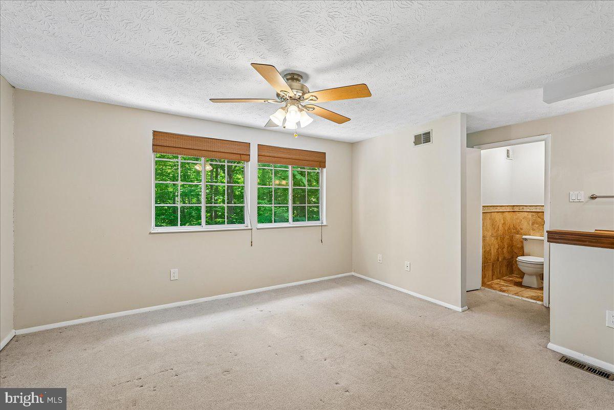 2331 Middle Creek Lane Reston, VA 20191 - Photo 26 of 78 a view of a livingroom with a ceiling fan and window