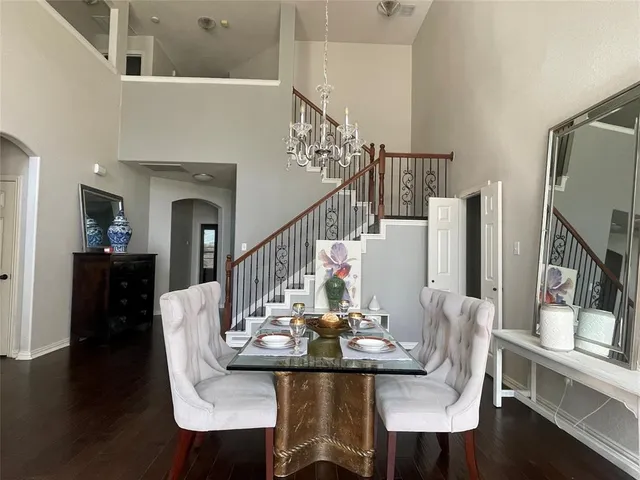 a view of a dining room with furniture a rug and wooden floor