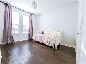 a bed sitting in a bedroom next to a window