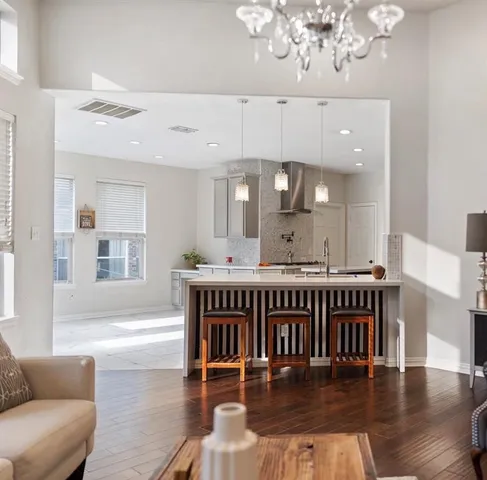 a living room with furniture and a chandelier