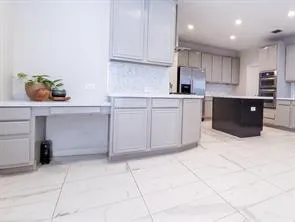 a kitchen with stainless steel appliances granite countertop a stove and a sink