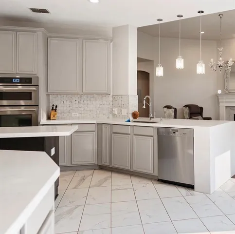 a kitchen with a sink cabinets and appliances
