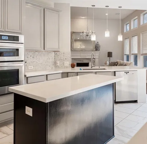 a kitchen with kitchen island a sink appliances and cabinets