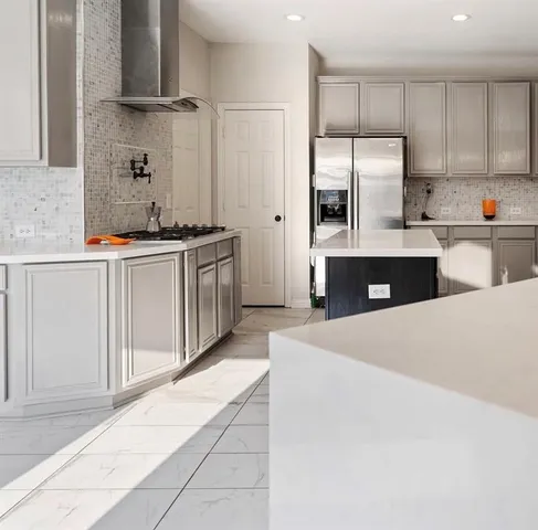 a kitchen with stainless steel appliances a sink and a refrigerator