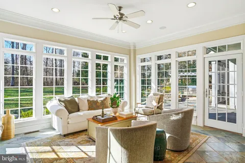 a living room with furniture fireplace and a table