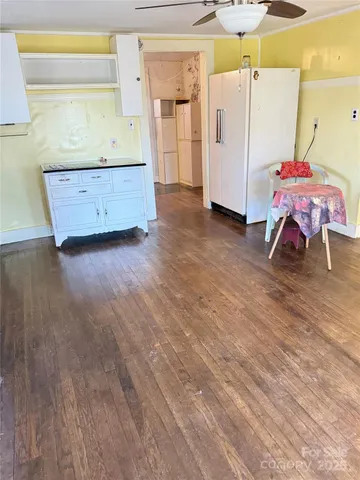 a room with wooden floor and furniture