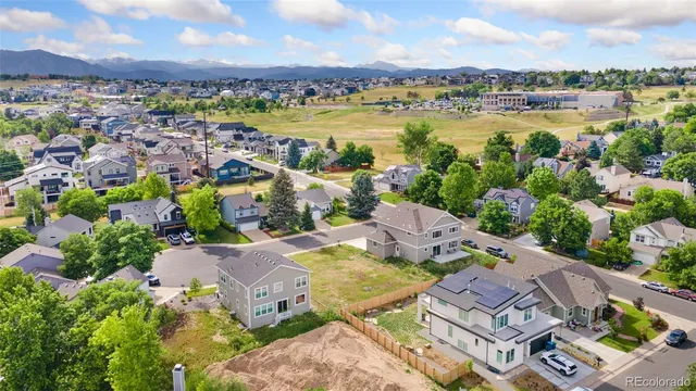 an aerial view of residential houses with outdoor space and river
