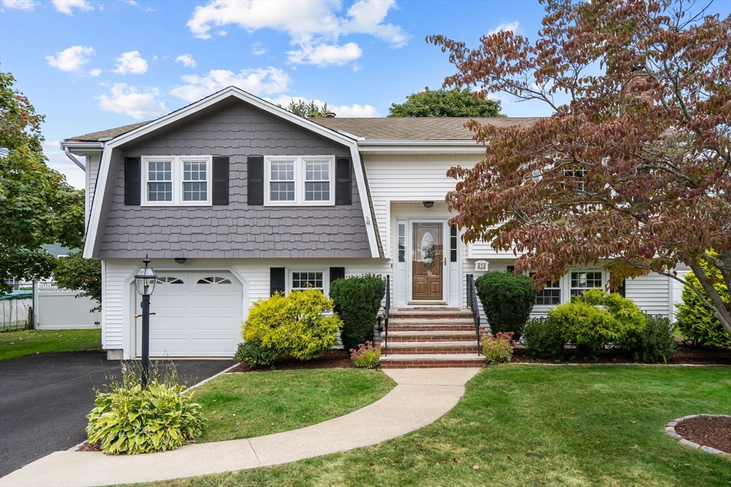 5 Brae Circle Woburn, MA 01801 - Photo 2 of 40 a front view of a house with a yard