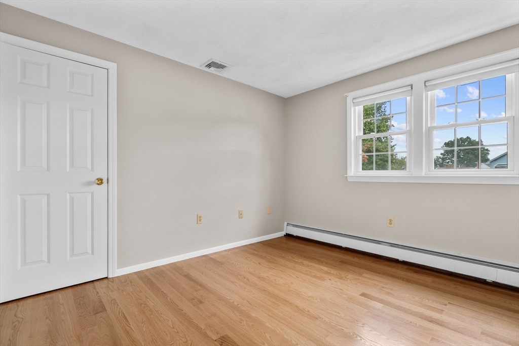 5 Brae Circle Woburn, MA 01801 - Photo 22 of 40 an empty room with wooden floor and windows