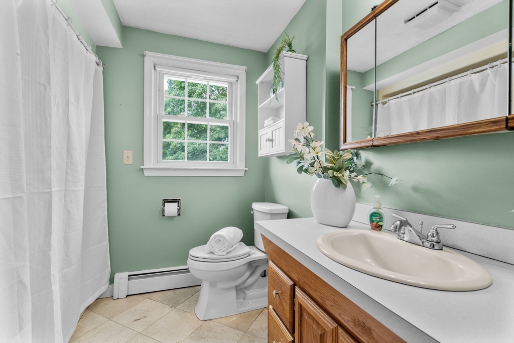 5 Brae Circle Woburn, MA 01801 - Photo 23 of 40 a bathroom with a granite countertop toilet sink and mirror
