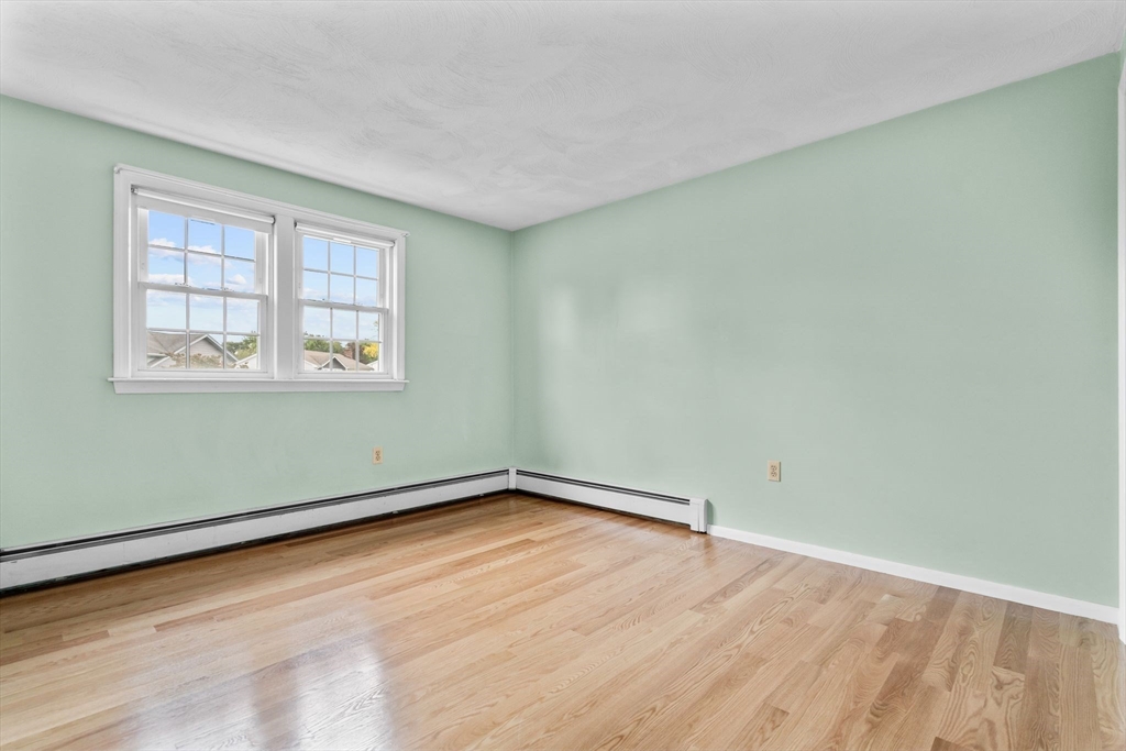 5 Brae Circle Woburn, MA 01801 - Photo 24 of 40 an empty room with wooden floor and windows