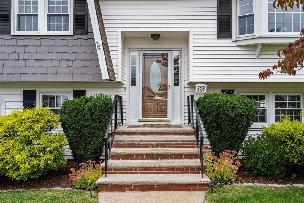 5 Brae Circle Woburn, MA 01801 - Photo 3 of 40 a front view of a house with potted plants