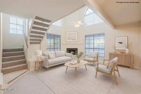 a view of an empty room with a fireplace and a window