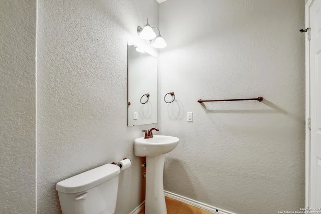 a bathroom with a sink mirror toilet and shower