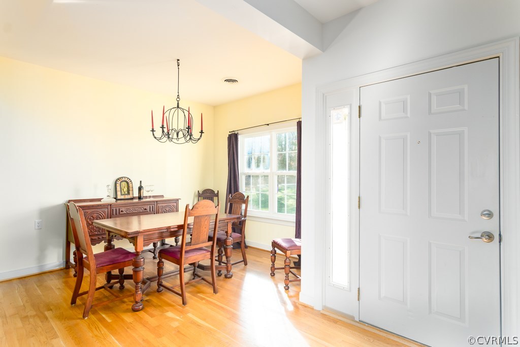 12620 Singer Road Midlothian, VA 23112 - Photo 3 of 28 a view of a dining room with furniture and a chandelier