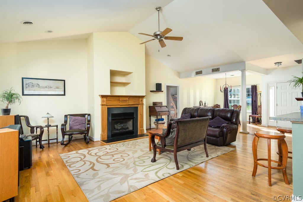 12620 Singer Road Midlothian, VA 23112 - Photo 5 of 28 a living room with furniture dining table and a fireplace