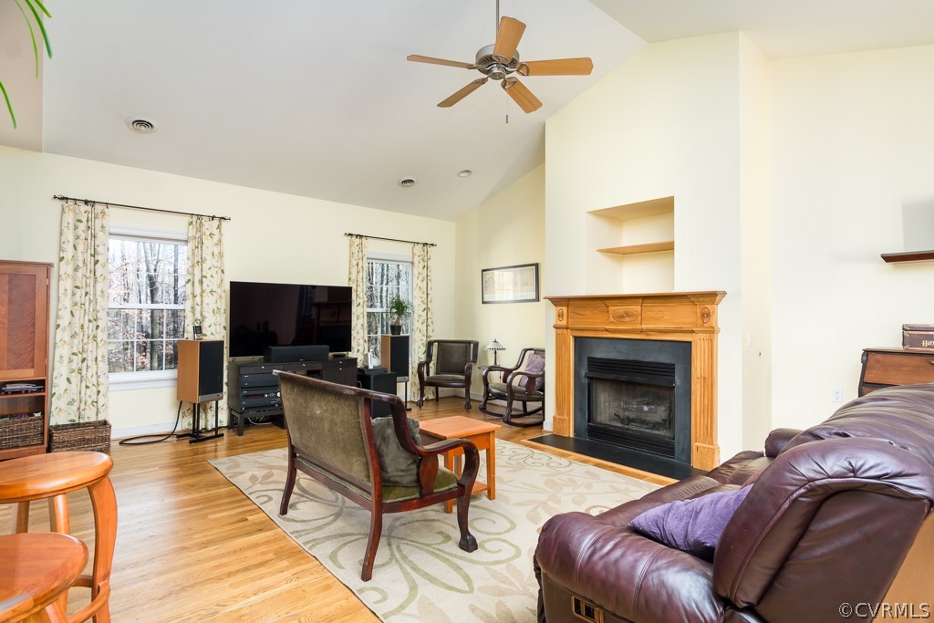 12620 Singer Road Midlothian, VA 23112 - Photo 6 of 28 a living room with furniture a flat screen tv and a fireplace