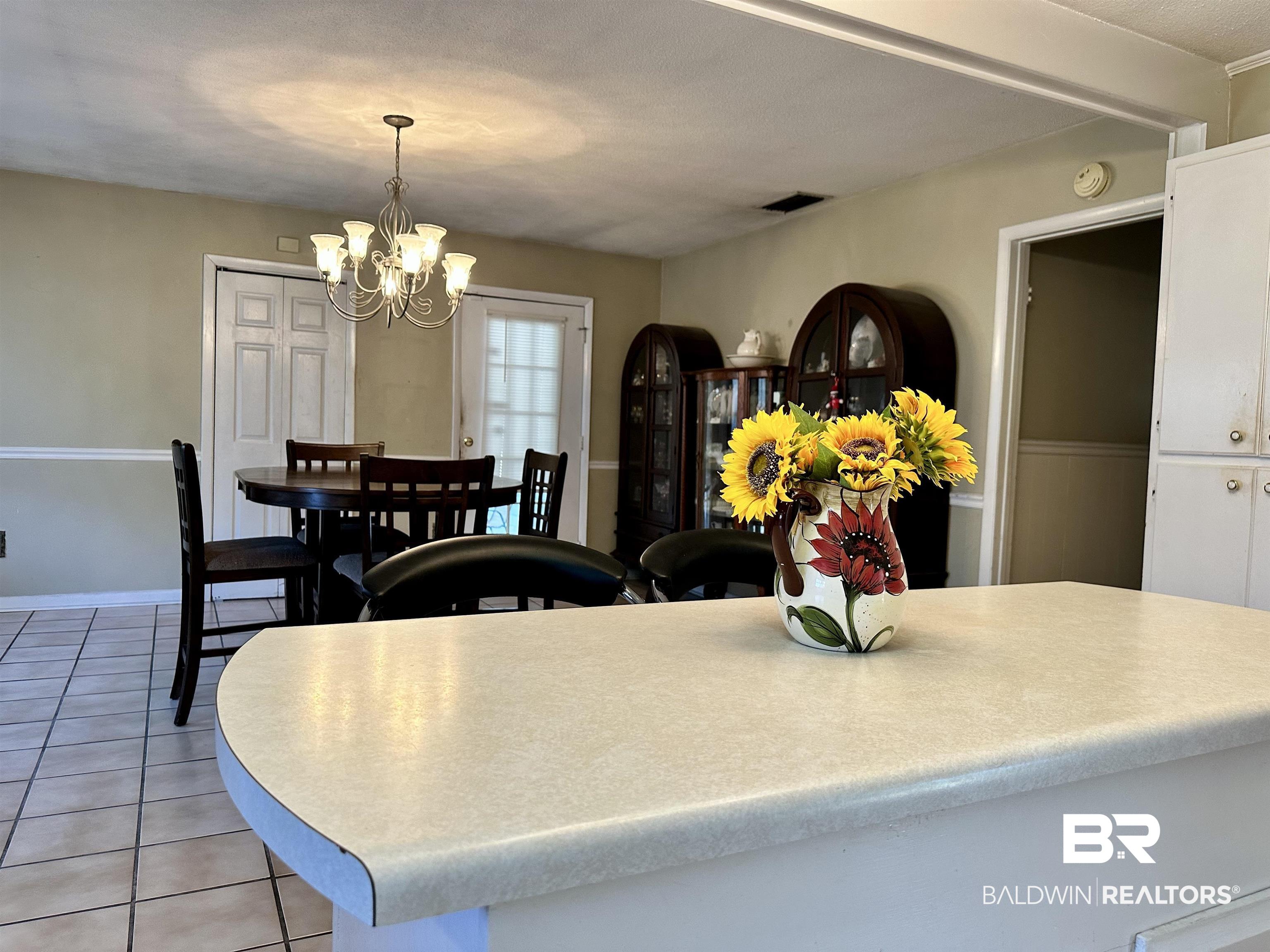 2593 Foshee Road Brewton, AL 36426 - Photo 4 of 15 Tiled dining room with a chandelier