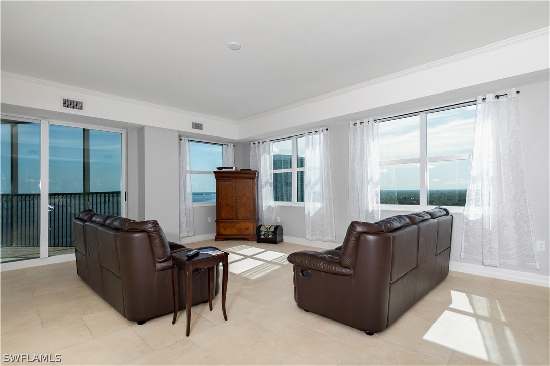 2797 First Street, Unit 1806 Fort Myers, FL 33916 - Photo 2 of 34 a living room with furniture and a flat screen tv