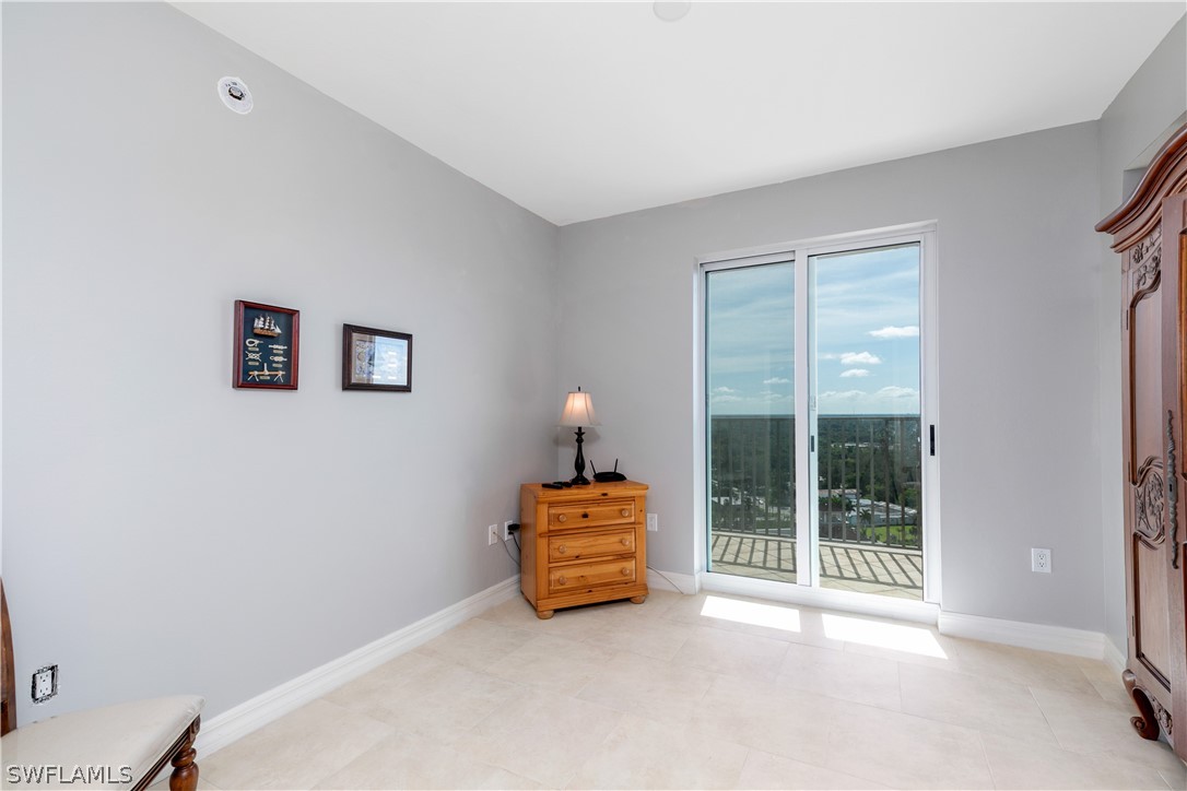 2797 First Street, Unit 1806 Fort Myers, FL 33916 - Photo 21 of 34 a wooden bench sitting in front of a window