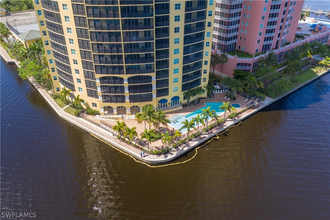 2797 First Street, Unit 1806 Fort Myers, FL 33916 - Photo 30 of 34 a blue swimming pool with outdoor seating and plants