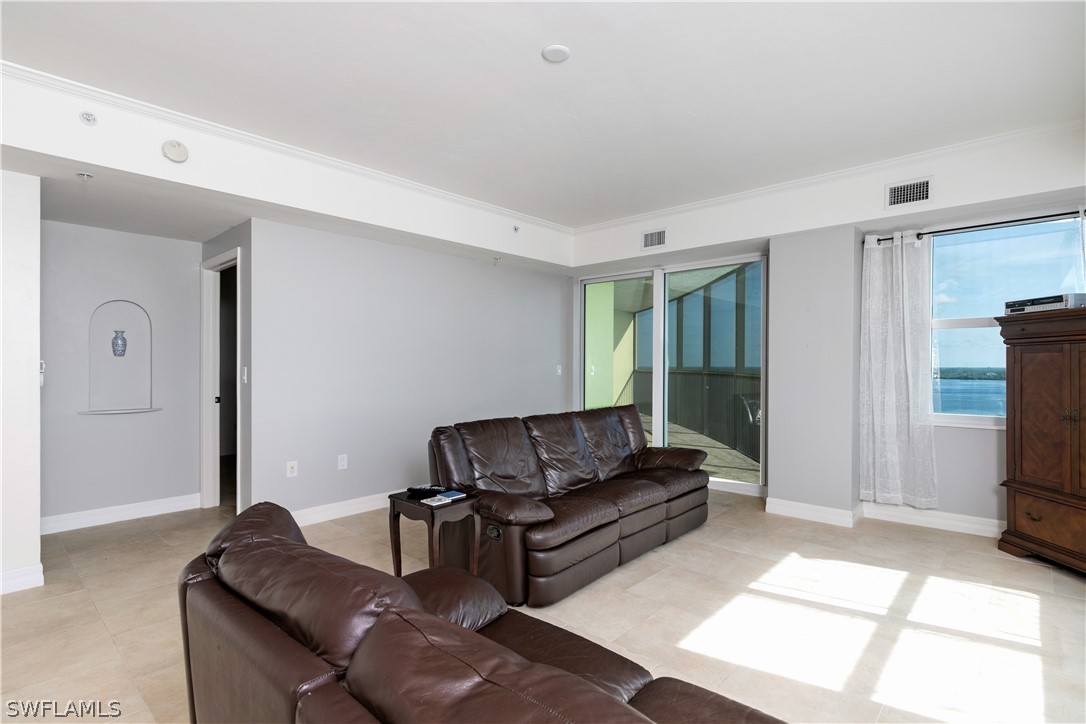 2797 First Street, Unit 1806 Fort Myers, FL 33916 - Photo 6 of 34 a living room with furniture and a flat screen tv