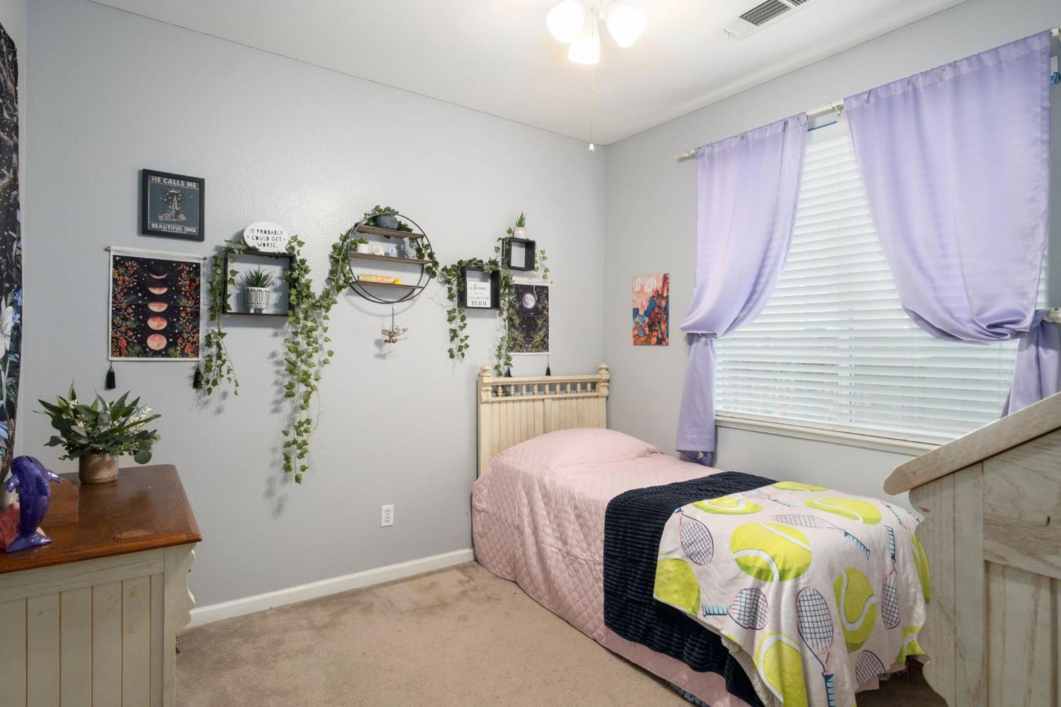 454 Sierra Avenue Reedley, CA 93654 - Photo 21 of 25 a bedroom with a bed and a potted plant