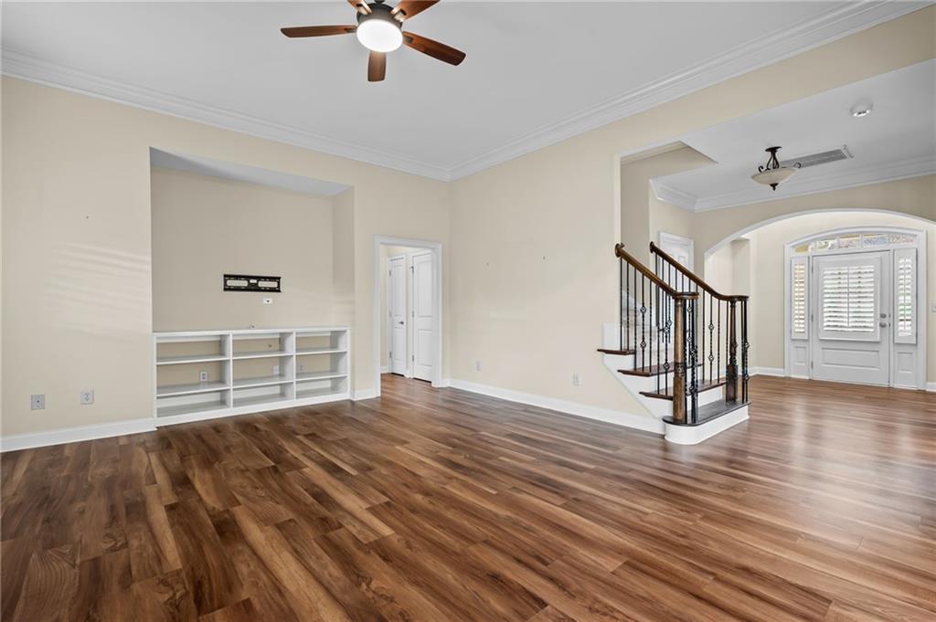 589 Lawton Bridge Road Southwest Smyrna, GA 30082 - Photo 11 of 52 a view of empty room with wooden floor and fan