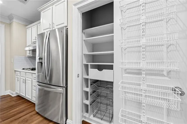 a kitchen with a refrigerator and cabinets