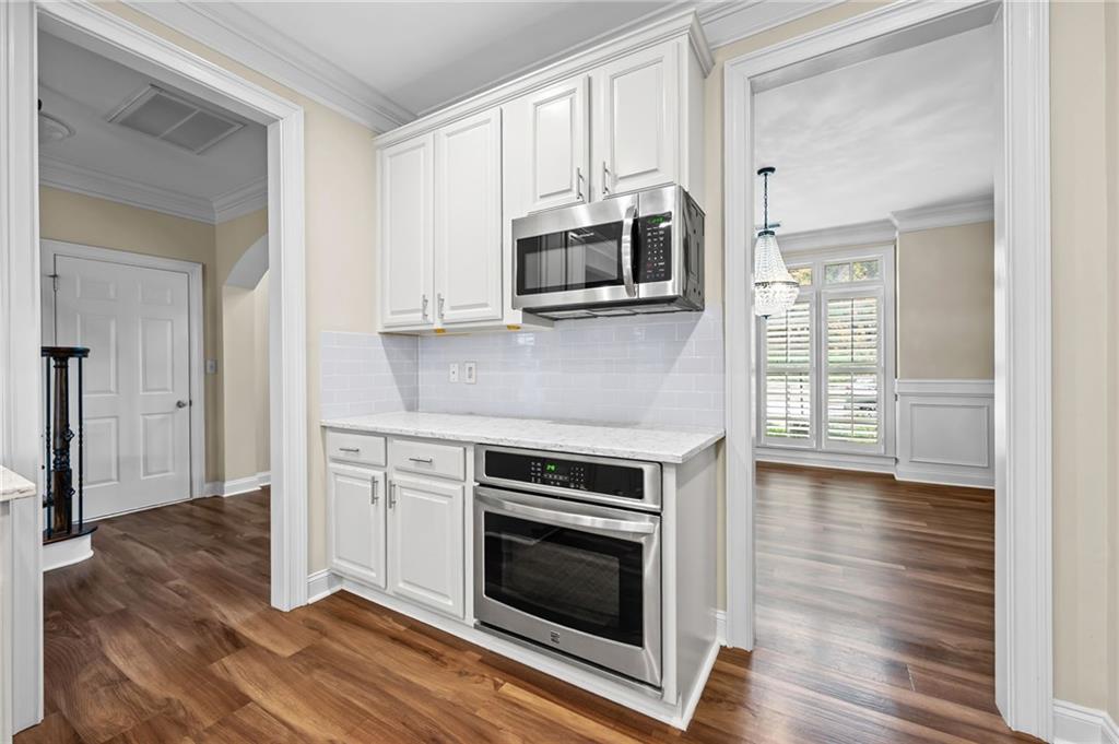 589 Lawton Bridge Road Southwest Smyrna, GA 30082 - Photo 15 of 52 a kitchen with stainless steel appliances granite countertop a stove microwave and sink