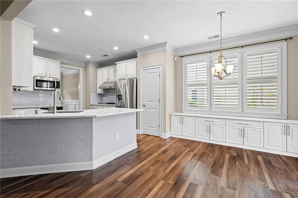 589 Lawton Bridge Road Southwest Smyrna, GA 30082 - Photo 18 of 52 a large kitchen with granite countertop a large counter top space a sink stainless steel appliances and cabinets