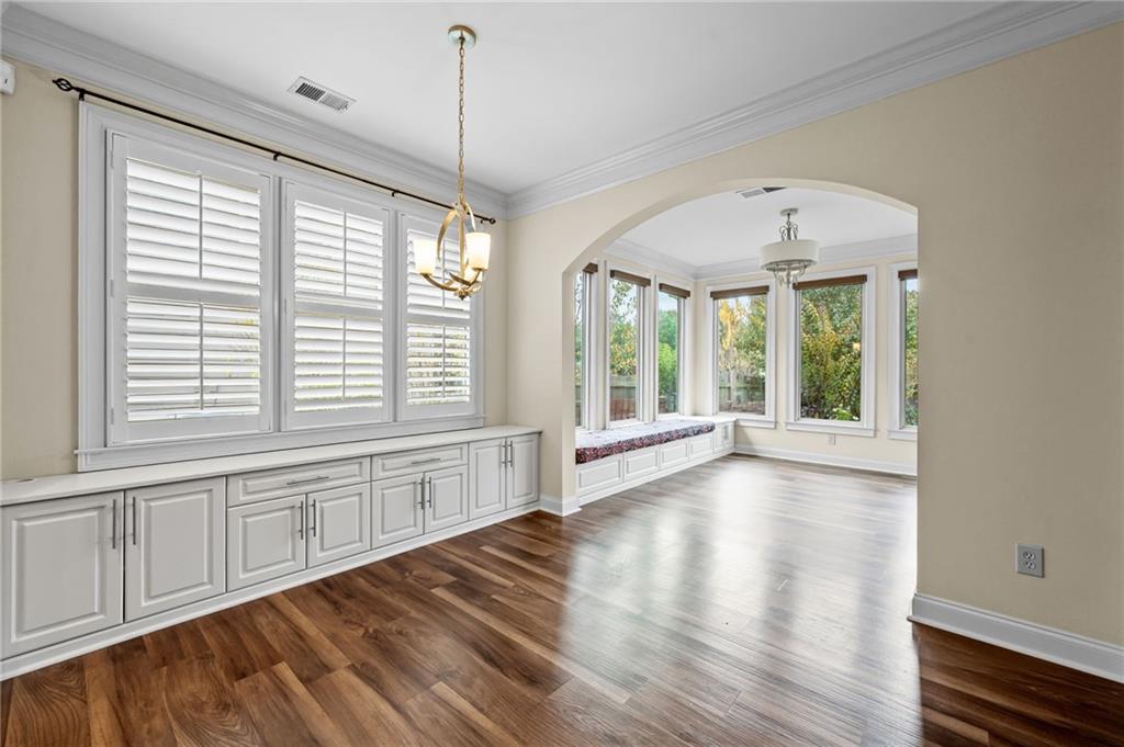 589 Lawton Bridge Road Southwest Smyrna, GA 30082 - Photo 19 of 52 a view of an empty room with wooden floor and a window