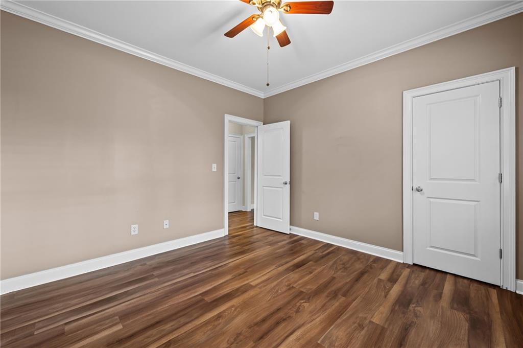 589 Lawton Bridge Road Southwest Smyrna, GA 30082 - Photo 24 of 52 a view of an empty room with window and wooden floor