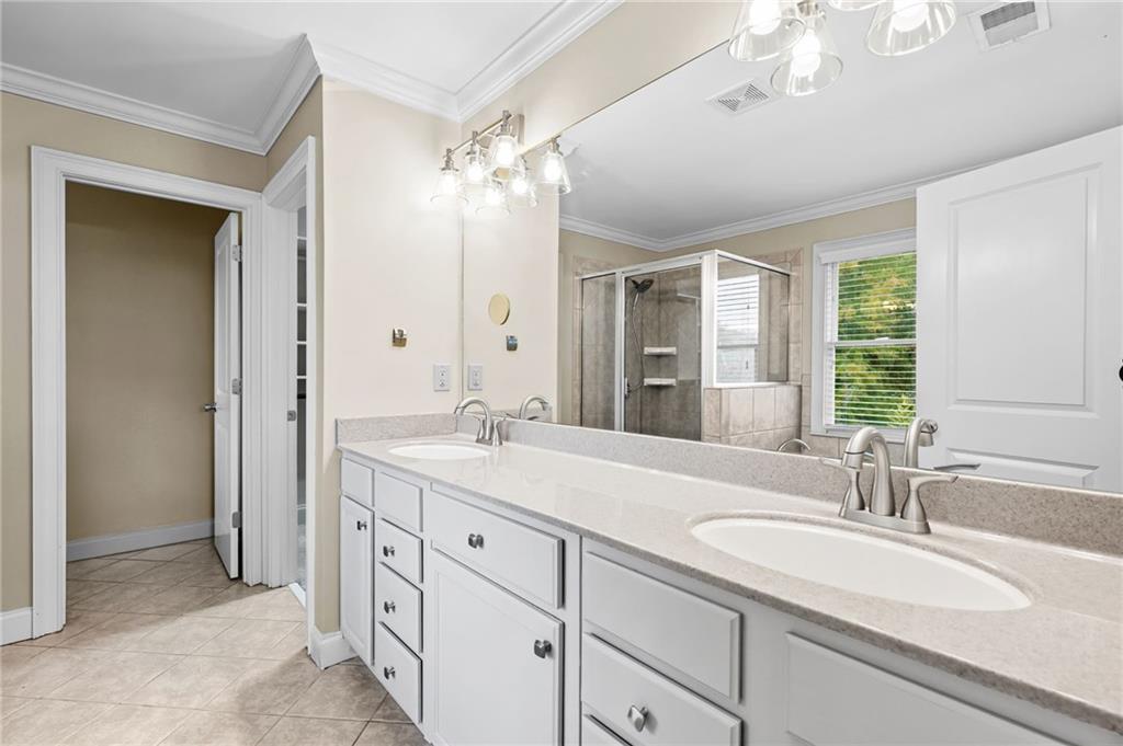 589 Lawton Bridge Road Southwest Smyrna, GA 30082 - Photo 30 of 52 a bathroom with double vanity sinks a vanity a lamp and a mirror