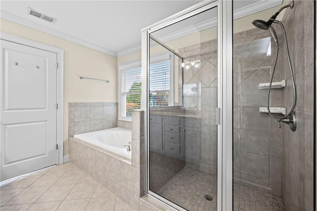 589 Lawton Bridge Road Southwest Smyrna, GA 30082 - Photo 31 of 52 a bathroom with a tub shower and sink