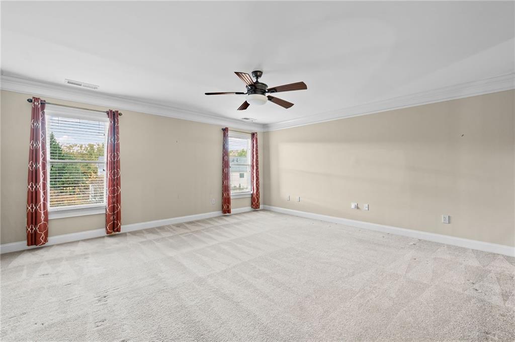 589 Lawton Bridge Road Southwest Smyrna, GA 30082 - Photo 34 of 52 an empty room with chandelier fan and windows