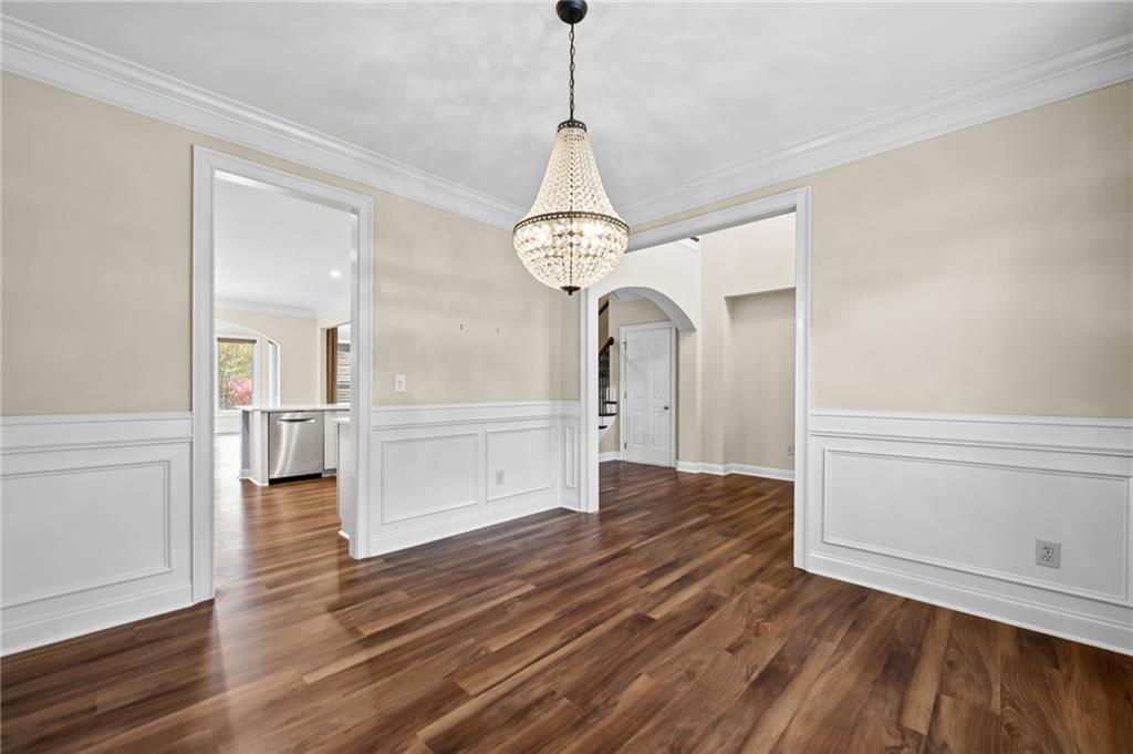 589 Lawton Bridge Road Southwest Smyrna, GA 30082 - Photo 7 of 52 a view of a room with wooden floor staircase and a chandelier