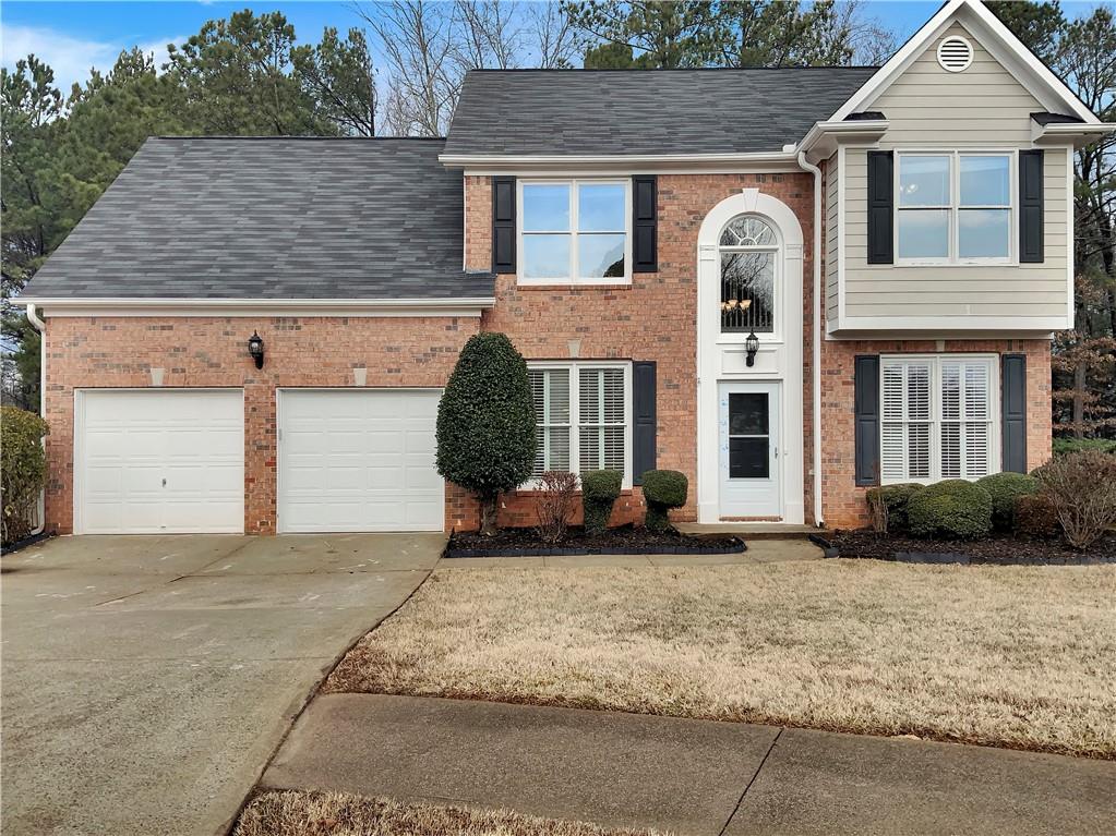 4156 Springhill Lane Kennesaw, GA 30144 - Photo 1 of 1 a front view of a house with garden