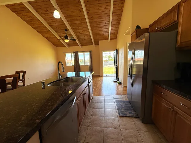 a kitchen with stainless steel appliances granite countertop a refrigerator a stove top oven a sink and dishwasher