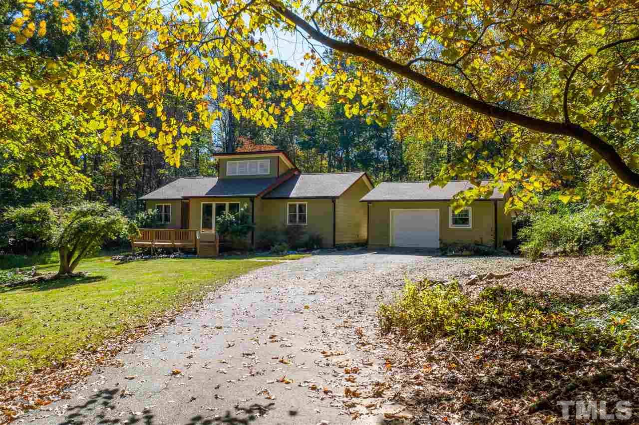 5901 Crabapple Road Durham, NC 27712 - Photo 1 of 20 a front view of a house with a yard and garage