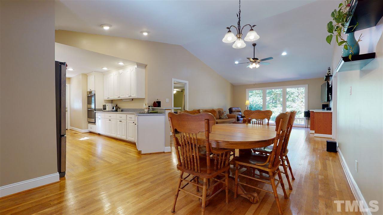 5901 Crabapple Road Durham, NC 27712 - Photo 11 of 20 a view of a dining room with furniture window and wooden floor