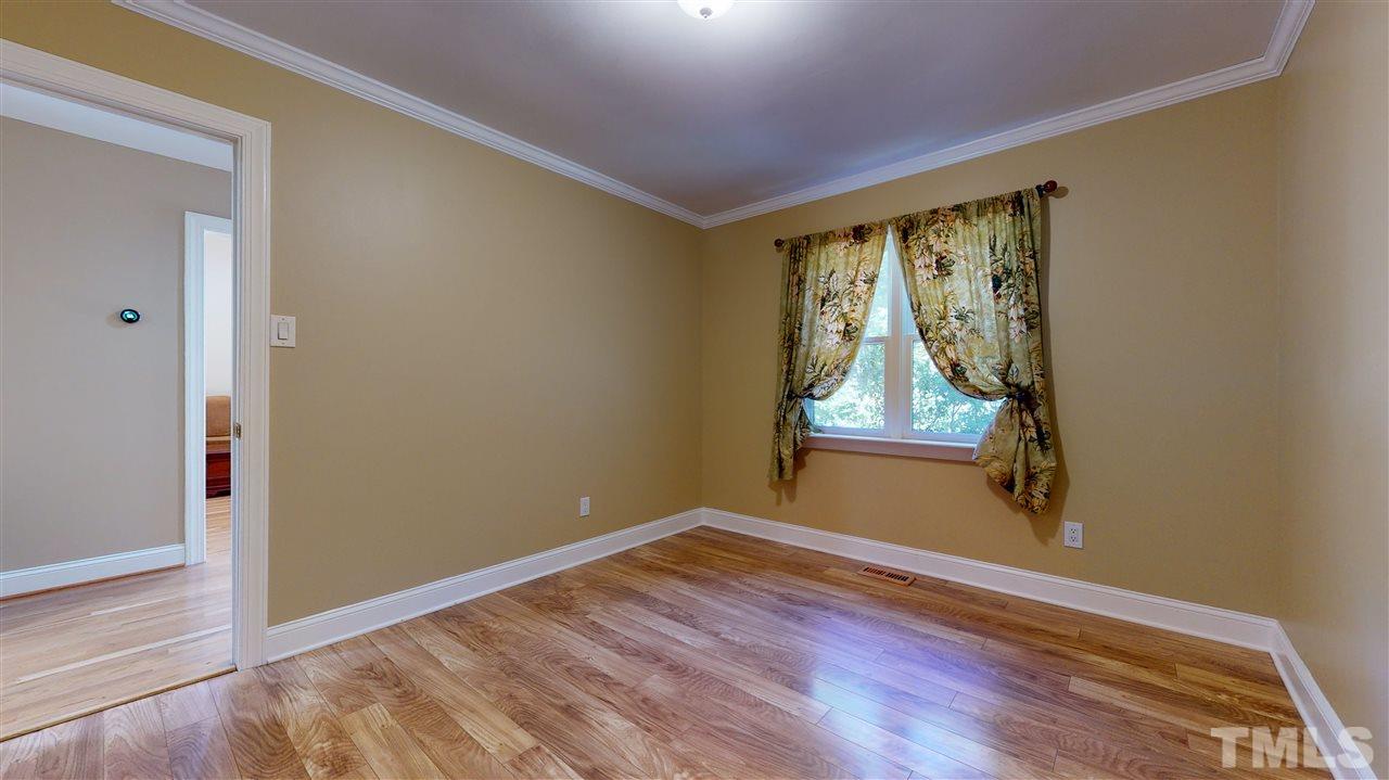 5901 Crabapple Road Durham, NC 27712 - Photo 15 of 20 an empty room with wooden floor and windows