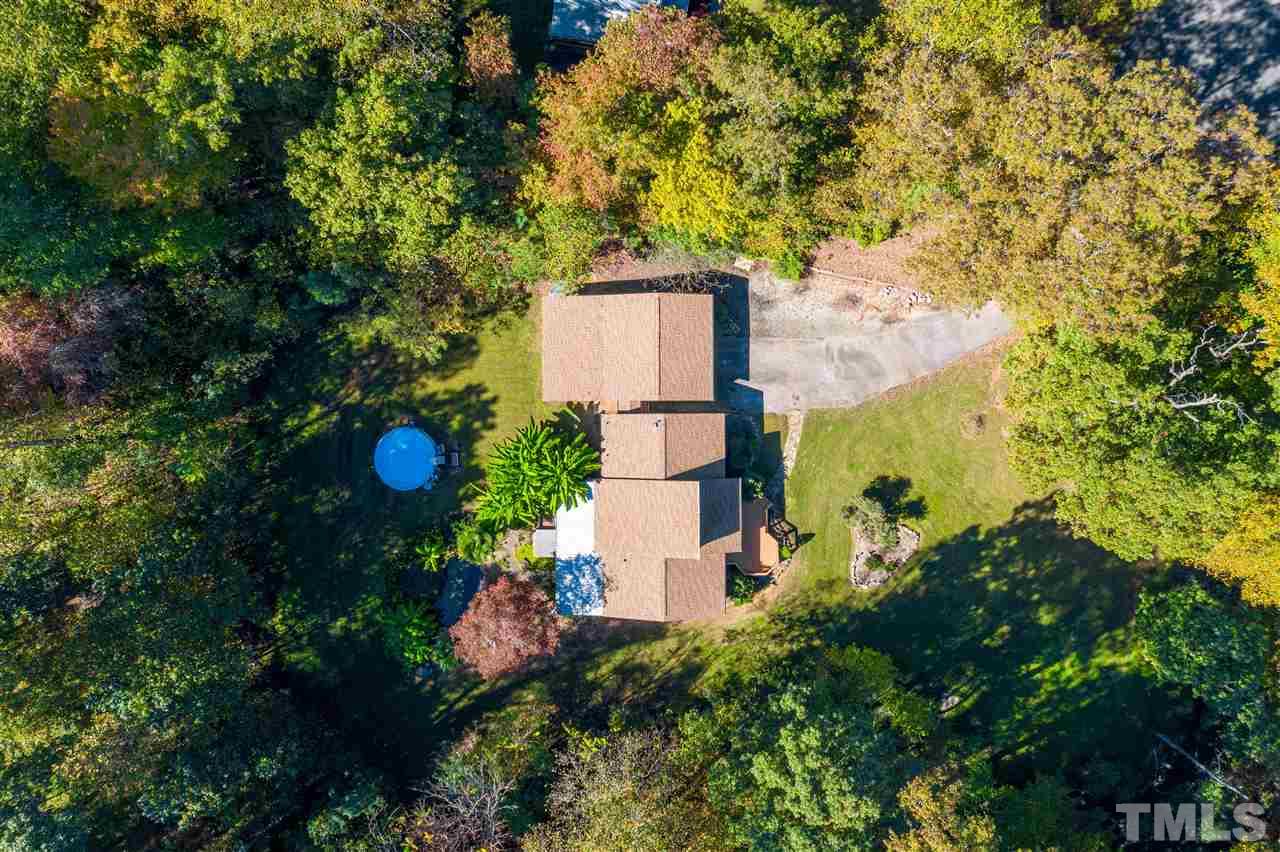 5901 Crabapple Road Durham, NC 27712 - Photo 19 of 20 an aerial view of a house with a yard and trees all around