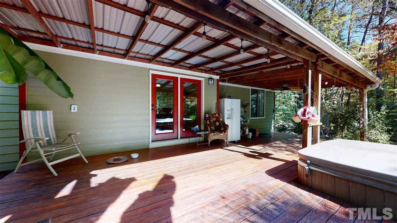 5901 Crabapple Road Durham, NC 27712 - Photo 6 of 20 a view of a patio with table and chairs and wooden floor